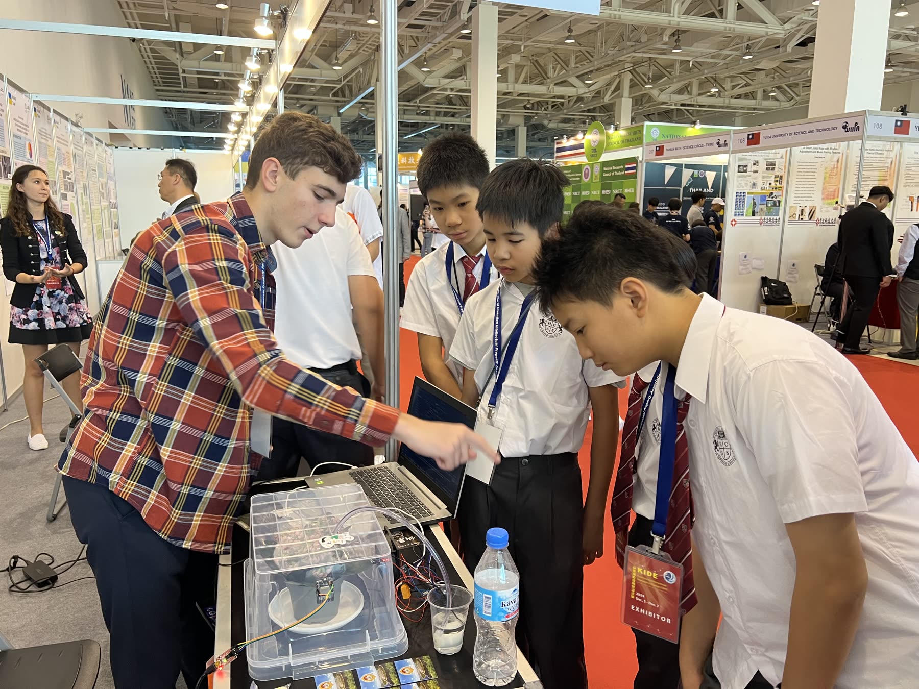 HCAS students demonstrating a prototype to a visitor at the 2024 expo